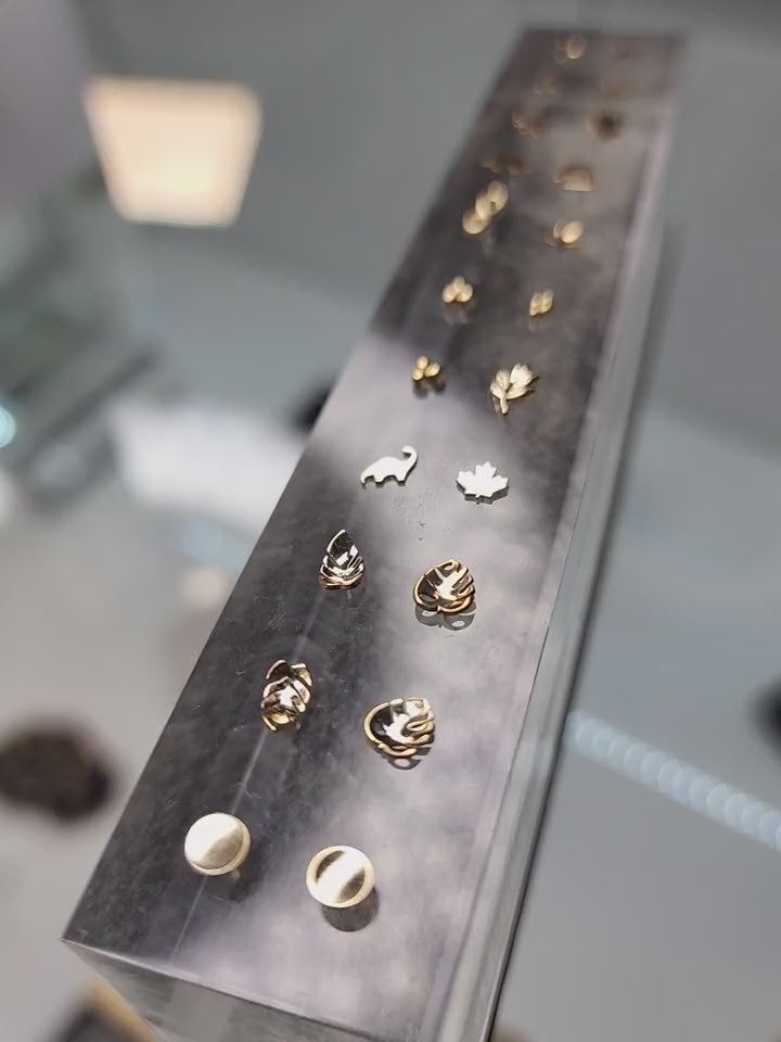 A close-up of small jewelry shapes on a display stand