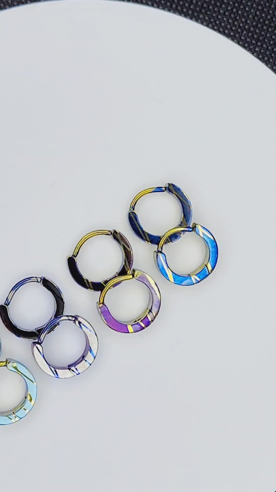 Elevated 80s titanium clickers with patterned anodized finishes