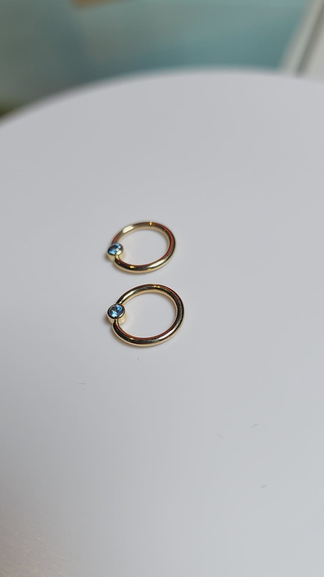 video of Solid 14kt Yellow and Rose Gold Forward facing gemmed seams. London Blue topaz in a Bezel set