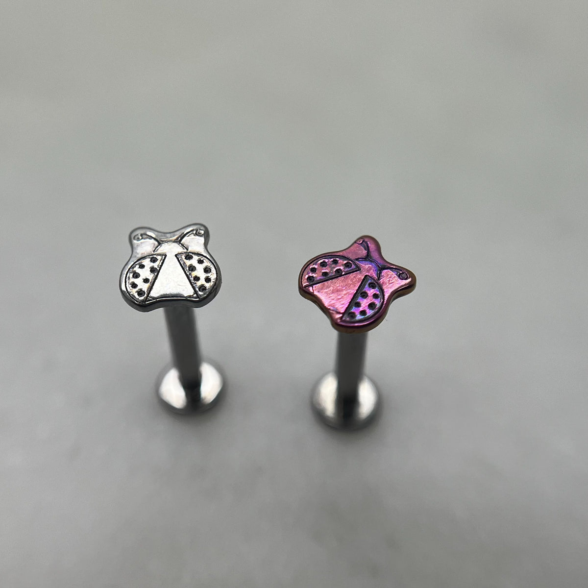 Polished and pink titanium ladybug ends on flat-back posts