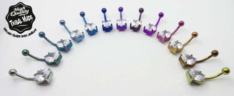 Teardrop gemstone titanium navel bars arranged by anodized colour