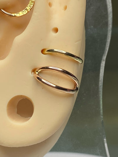 Gold split seam rings on an ear display model