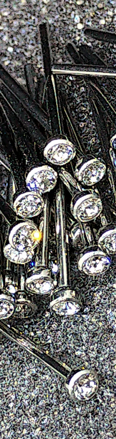 Clear cubic zirconia titanium nostril studs on a textured display