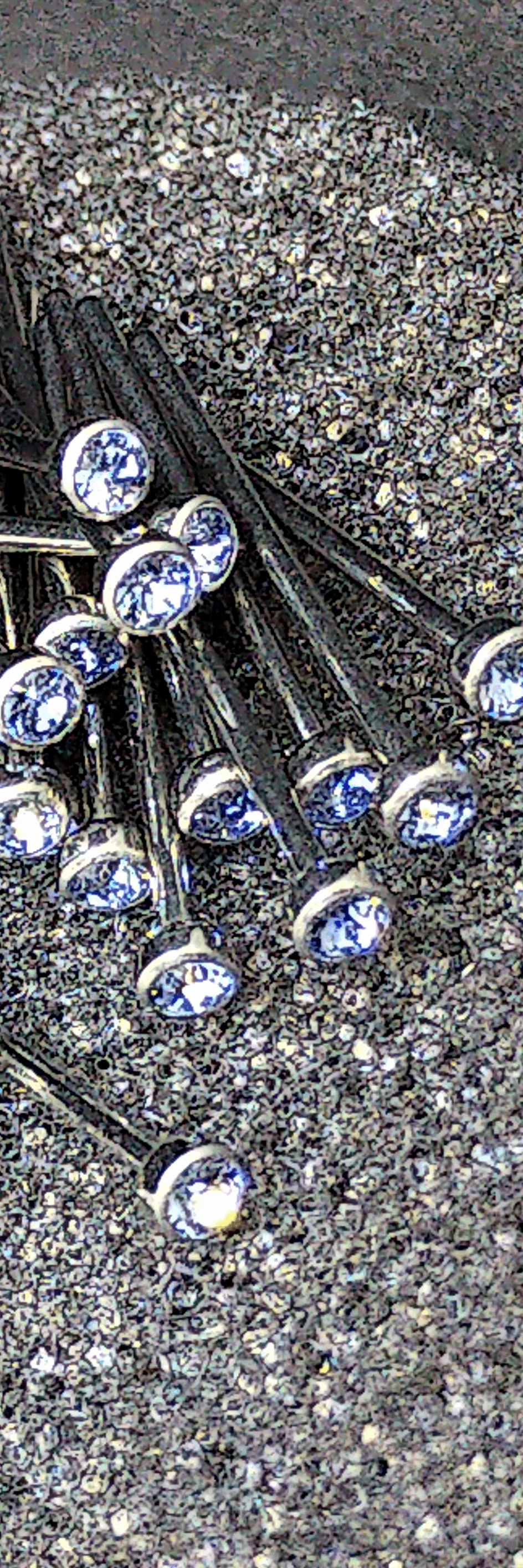 Blue cubic zirconia titanium nostril studs on a textured display