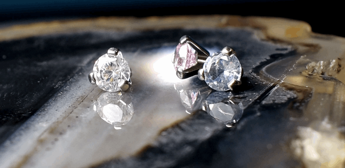Clear, pink and blue cubic zirconia beads in three-prong titanium settings