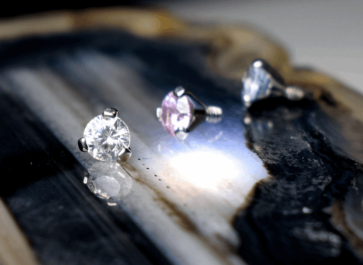 Clear, pink and blue cubic zirconia beads in three-prong titanium settings
