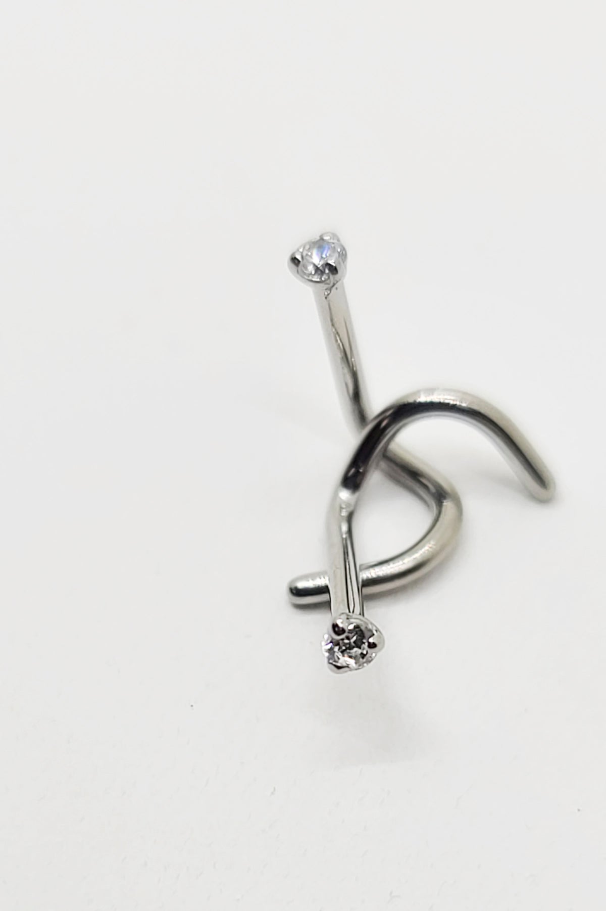 Titanium nostril screw with a clear prong-set gemstone