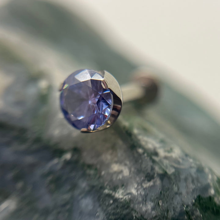 Violet-coloured 3 mm prong-set titanium bead with backing, made in Calgary