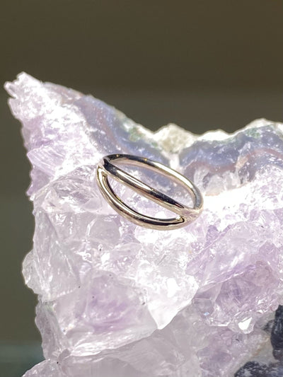 White gold split seam ring displayed on pale crystal