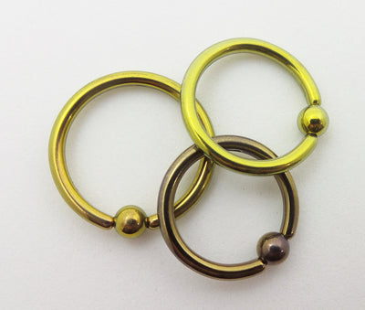 Titanium captive bead rings in yellow, gold and bronze finishes
