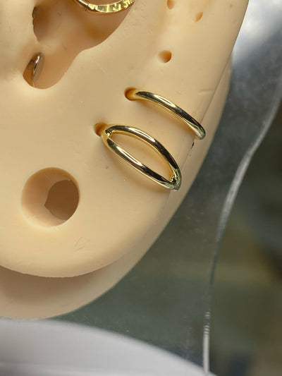 Gold split seam rings on an ear display model