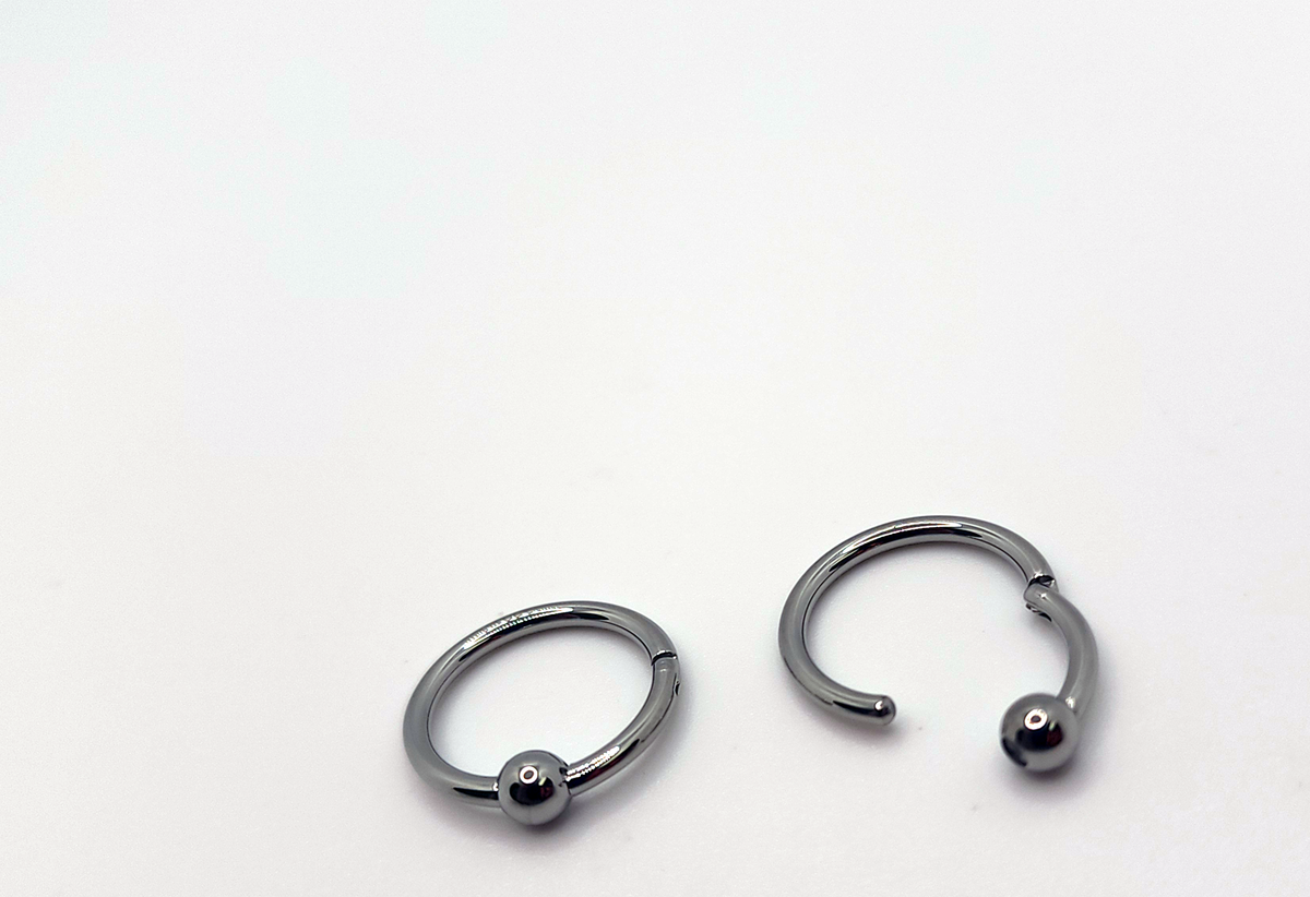 Polished titanium captive bead rings shown open and closed