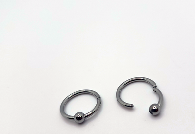 Polished titanium captive bead rings shown open and closed