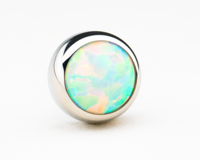 Pale blue-white synthetic opal in a polished titanium threadless setting