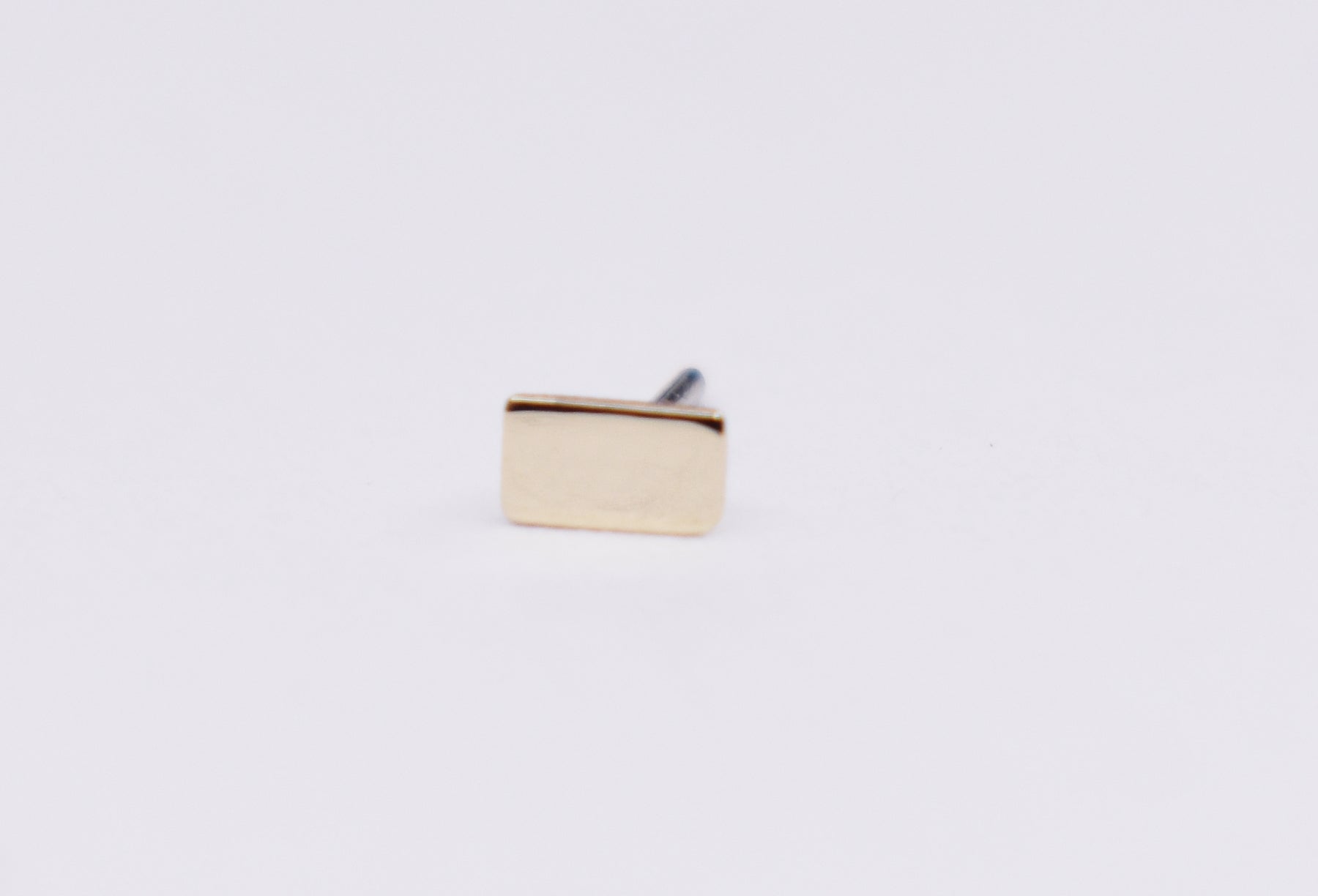 Solid 14kt Rose gold threadless top. Rectangle basic shape.